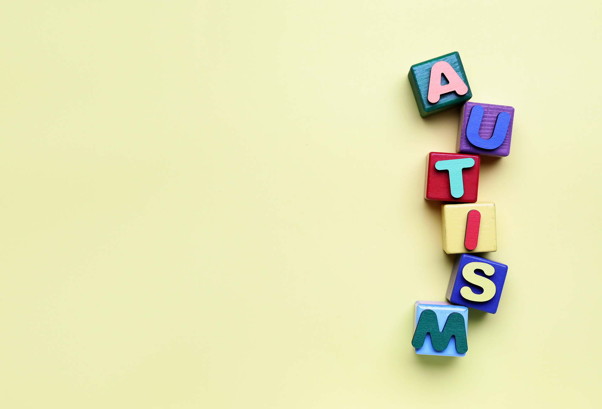 Cubes with Word AUTISM on Beige Background