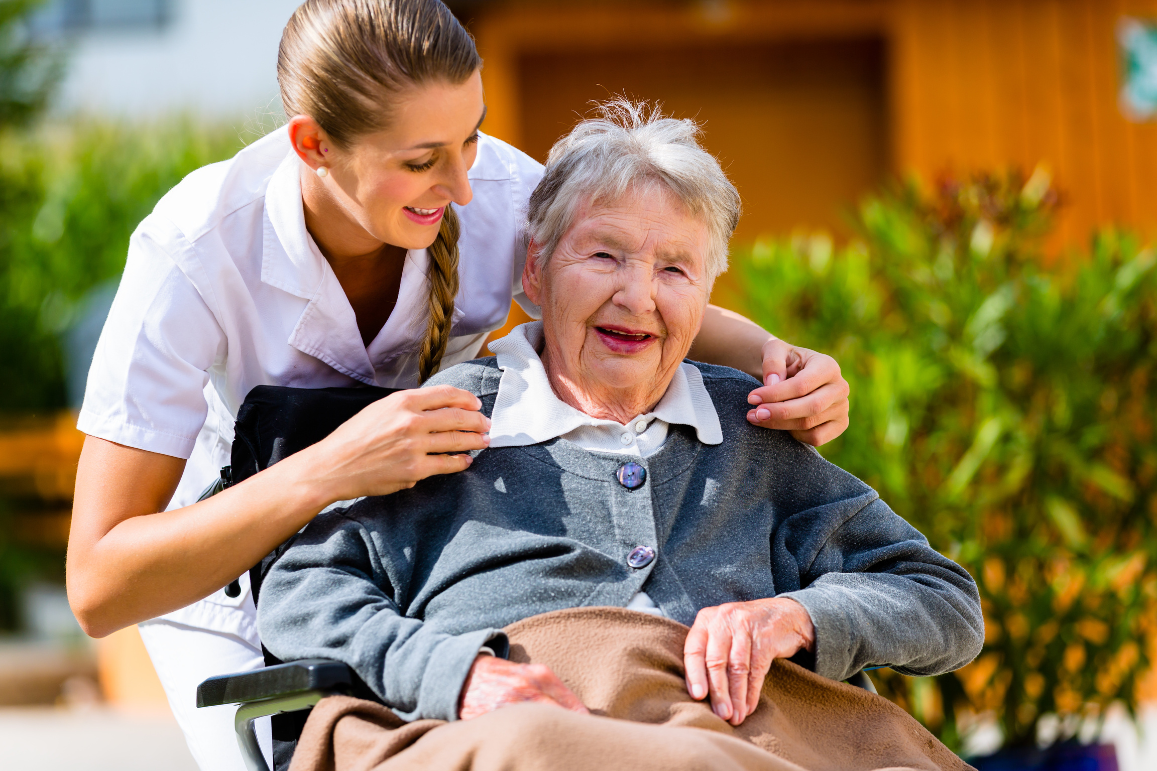 Senior Woman in Nursing Home with Nurse in Garden